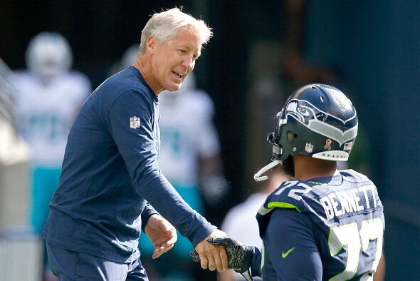SEATTLE, WA - SEPTEMBER 11:  Head coach Pete Carroll of the Seattle Seahawks greets defensive end Michael Bennett #72 before an NFL game against the Miami Dolphins at CenturyLink Field on September 11, 2016 in Seattle, Washington.  (Photo by Otto Greule J