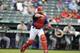 ARLINGTON, TX - SEPTEMBER 13: Catcher Ivan Rodriguez #7 of the Texas Rangers fields his position as he throws to first base after fielding a ball hit out in front of home plate during the game against the Seattle Mariners at Rangers Ballpark in Arlington