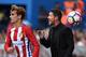 Atletico Madrid's French forward Antoine Griezmann (L) throws the ball beside Atletico Madrid's Argentinian coach Diego Simeone during the Spanish league football match Club Atletico de Madrid vs RC Deportivo de la Coruna at the Vicente Calderon stadium i
