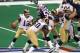 3 Feb 2002: Quarterback Kurt Warner #13 of the St. Louis Rams scrambles in the pocket as defensive end Willie McGinest tries to get to him during Super Bowl XXXVI between the New England Patriots and the St. Louis Rams at the Superdome in New Orleans, Lo