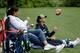 Anna Wilson flips a football as she watches her brother Russell at the Seahawks' 2016 training camp with their mother, Tammy Wilson.