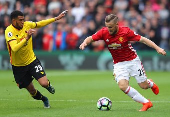 WATFORD, ENGLAND - SEPTEMBER 18: Luke Shaw of Manchester United (R) takes the ball past Etienne Capoue of Watford (L) during the Premier League match between Watford and Manchester United at Vicarage Road on September 18, 2016 in Watford, England. (Phot