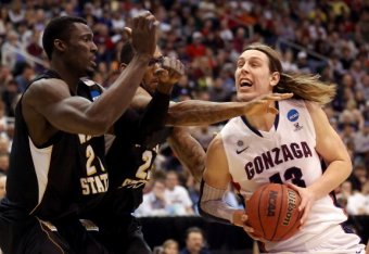 SALT LAKE CITY, UT - MARCH 23:  Kelly Olynyk #13 of the Gonzaga Bulldogs drives to the basket against Ehimen Orukpe #21 and Carl Hall #22 of the Wichita State Shockers in the first half during the third round of the 2013 NCAA Men's Basketball Tournament a