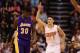 PHOENIX, AZ - FEBRUARY 15: Devin Booker #1 of the Phoenix Suns reacts to a three point shot ahead of Julius Randle #30 of the Los Angeles Lakers during the first half of the NBA game at Talking Stick Resort Arena on February 15, 2017 in Phoenix, Arizona.