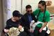 Cody Garbrandt (center) rests in the Claymont High School administrative office while waiting for his hometown's celebratory parade to start on January 22, 2017, along with his girlfriend Danny Pimsanguan (right)—and her Chihuahua, Casey, and Maddux Maple (left).