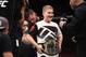 Cody Garbrandt (back) places the UFC title belt around Maddux Maple's waist after defeating Dominick Cruz in their UFC bantamweight championship bout during the UFC 207 event at T-Mobile Arena on December 30, 2016, in Las Vegas.