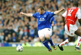 LIVERPOOL - 19 OCTOBER:  Wayne Rooney of Everton takes on Lauren of Arsenal during the FA Barclaycard Premiership match between Everton and Arsenal at Goodison Park in Liverpool on October 19, 2002. Everton won 2-1. (photo by Shaun Botterill/Getty Images.