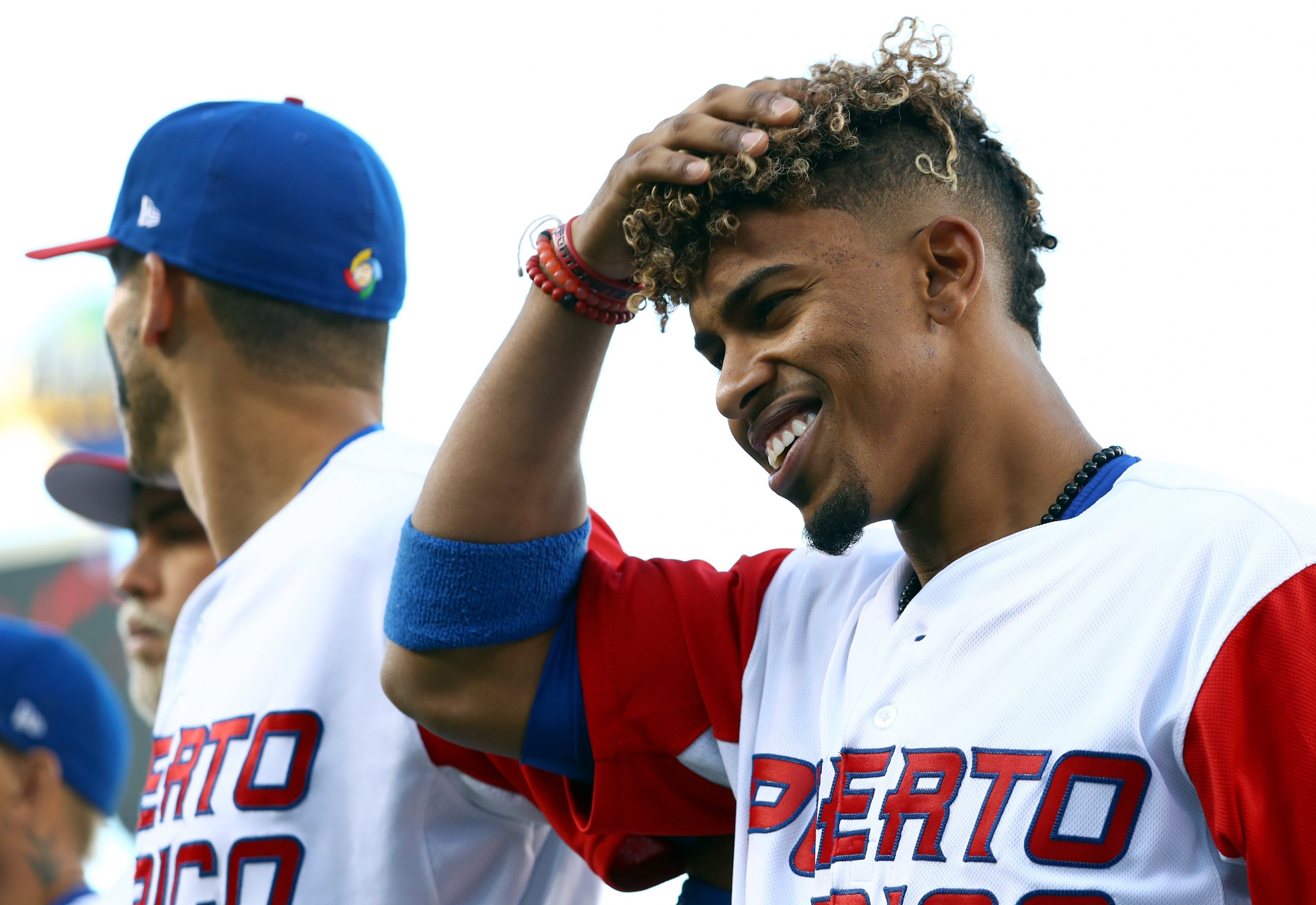 Puerto Rico infielder Francisco Lindor, right, yells after he