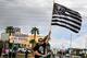 LAS VEGAS, NV - MARCH 27: Oakland Raiders fan Matt Gutierrez of Nevada waves a Raiders flag in front of the Welcome to Fabulous Las Vegas sign after National Football League owners voted 31-1 to approve the team's application to relocate to Las Vegas dur