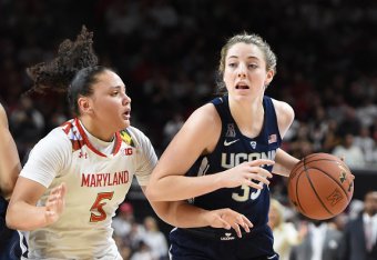 COLLEGE PARK, MD - DECEMBER 29:  Katie Lou Samuelson #33 of the Connecticut Huskies dribbles by Destiny Slocum #5 of the Maryland Terrapins during a women's college basketball game at the XFinity Center on December 29, 2016 in College Park, Maryland.  The