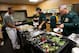Members of the Oakland A's dig into the food spread in the clubhouse before a game on April 7, 2016.
