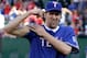 Dirk flexes his bicep after throwing out the honorary first pitch before a game between the New York Mets and Texas Rangers on June 24, 2011.