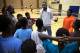 Omaha Talons Academy Director Koang Doluony talks with a group of fifth-grade basketball players during a practice at Omaha North High Magnet School.