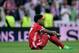 Bayern Munich's Austrian defender David Alaba sits on the field at the end of the UEFA Champions League quarter-final second leg football match Real Madrid vs FC Bayern Munich at the Santiago Bernabeu stadium in Madrid in Madrid on April 18, 2017. / AFP P