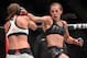 Jedrzejczyk throws a spinning backfist at Kowalkiewicz during their fight.