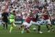 Liverpool's Brazilian midfielder Philippe Coutinho (L) shoots past West Ham United's Welsh defender James Collins (2R) to score the second goal during the English Premier League football match between West Ham United and Liverpool at The London Stadium, i