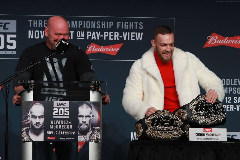 NEW YORK, NY - NOVEMBER 10: Conor McGregor of Ireland takes Eddie Alvarez's lightweight belt during the UFC 205 press conference at The Theater at Madison Square Garden on November 10, 2016 in New York City. (Photo by Michael Reaves/Getty Images)
