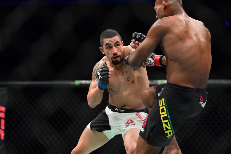 Robert Whittaker looks for a left hand against Jacare Souza.