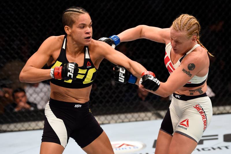 LAS VEGAS, NV - MARCH 05: (L-R) Amanda Nunes of Brazil punches Valentina Schevchenko in their women's bantamweight bout during the UFC 196 event inside the MGM Grand Garden Arena on March 5, 2016 in Las Vegas, Nevada. (Photo by Josh Hedges/Zuffa LLC/Zuff