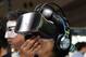 A woman attaches a 'IDEALENS K2+' VR device presented by VR Japan at the VR/AR World Exhibition as part of the Advanced Content Technology Expo in Tokyo on June 29, 2017. / AFP PHOTO / Kazuhiro NOGI (Photo credit should read KAZUHIRO NOGI/AFP/Gett