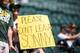 SEATTLE, WA - JULY 09: Oakland fans hold a sign referencing Oakland Athletics pitcher Sonny Gray, who has been drawing interest from other teams ahead of the July 31 trade deadline, before the game against the Seattle Mariners at Safeco Field on July 9,