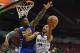 LAS VEGAS, NV - JULY 12: C.J. Williams #14 of the Minnesota Timberwolves drives to the basket against Jordan Bell #2 of the Golden State Warriors during the 2017 Summer League at the Thomas & Mack Center on July 12, 2017 in Las Vegas, Nevada. Golden Stat