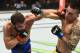 UNIONDALE, NY - JULY 22: (L-R) Jimmie Rivera punches Thomas Almeida of Brazil in their bantamweight bout during the UFC Fight Night event inside the Nassau Veterans Memorial Coliseum on July 22, 2017 in Uniondale, New York. (Photo by Josh Hedges/Zuffa LL