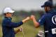 US golfer Jordan Spieth and caddie Michael Greller celebrate after Spieth makes his putt on the 16th green for birdie during his final round 69 on day four of the 2017 Open Golf Championship at Royal Birkdale golf course near Southport in north west Engla