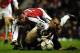 LONDON, UNITED KINGDOM: Arsenal's Juan (L) tussles with Grimsby Town's Paul Groves (R) in The Worthington Cup 4th round match at Highbury in London 27 November 2001. Arsenal's Brazilian player Edu scored an early first half goal to put Arsenal ahead 1-0