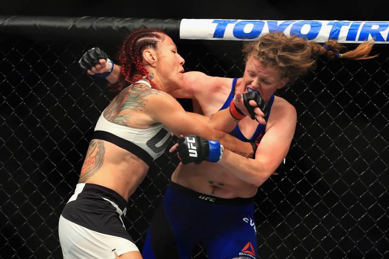 ANAHEIM, CA - JULY 29: Cris Cyborg of Brazil (L) fights Tonya Evinger during their Featherweight Title fight at UFC 214 at Honda Center on July 29, 2017 in Anaheim, California. (Photo by Sean M. Haffey/Getty Images)
