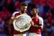 LONDON, ENGLAND - AUGUST 06: Olivier Giroud and Theo Walcott of Arsenal celebrate with the Community Shield on the pitch after the FA Community Shield match between Chelsea and Arsenal at Wembley Stadium on August 6, 2017 in London, England. (Photo by D