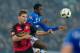 GELSENKIRCHEN, GERMANY - DECEMBER 17: Florian Niederlechner of Freiburg and Abdul Rahman Baba of Schalke battle for the ball during the Bundesliga match between FC Schalke 04 and SC Freiburg at Veltins-Arena on December 17, 2016 in Gelsenkirchen, Germany.