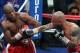 Floyd Mayweather (L) backs away from a right from Miguel Cotto during of their WBA super welterweight title fight at the MGM Grand in Las Vegas on May 5, 2012. Mayweather won the WBA super welterweight title in a 12-round unanimous decision. AFP PHOTO