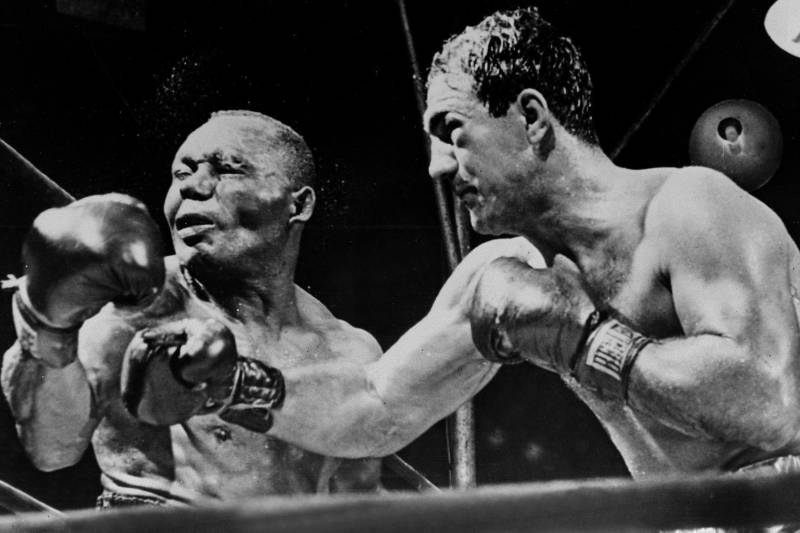 NEW YORK, NY - SEPTEMBER 1: American boxing champion Rocky Marciano (R) throws a right swing to his country fellow heavyweight boxing world champion Joe Walcott, September 1952 in New York, in the fifteenth round of their fight for the title that he take