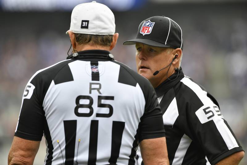 BALTIMORE, MD - OCTOBER 2: Line judge Rusty Baynes #59 confers with referee Ed Hochuli #85 during the game between the Baltimore Ravens and the Oakland Raiders at M&T Bank Stadium on October 2, 2016 in Baltimore, Maryland. The Raiders defeated the Ravens