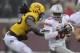 MINNEAPOLIS, MN - NOVEMBER 15: J.T. Barrett #16 of the Ohio State Buckeyes scrambles under pressure from De'Vondre Campbell #26 of the Minnesota Golden Gophers during the fourth quarter of the game on November 15, 2014 at TCF Bank Stadium in Minneapolis,