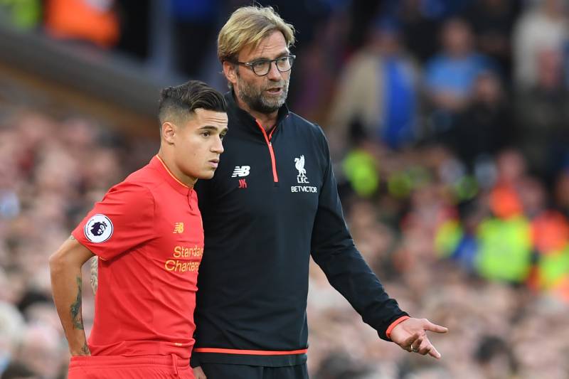 Liverpool's German manager Jurgen Klopp (R) speaks to Liverpool's Brazilian midfielder Philippe Coutinho on the touchline during the English Premier League football match between Liverpool and Leicester City at Anfield in Liverpool, north west England on 