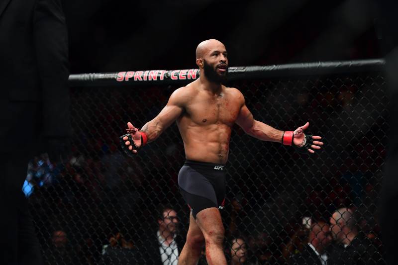 2Apr 15, 2017; Kansas City, MO, USA; Demetrious Johnson (red) celebrates following the win over and Wilson Reis (not pictured) during UFC Fight Night at Sprint Center. Mandatory Credit: Ron Chenoy-USA TODAY Sports