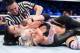 Shayna Baszler traps Candice LeRae in a rear naked choke.