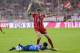 Bayern Munich's German striker Thomas Mueller and Leverkusen's Chilian midfielder Charles Aranguiz vie for the ball during the German First division Bundesliga football match FC Bayern Munich vs Bayer 04 Leverkusen in Munich, southern Germany, on August 1