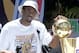 LOS ANGELES, UNITED STATES: Kobe Bryant puts his hand on the NBA championship trophy at the end of the Los Angeles Lakers victory parade through downtown Los Angeles 21 June 2000. About 200,000 fans lined the streets to cheer on the Lakers NBA 2000 ch