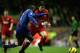 LIVERPOOL, ENGLAND - NOVEMBER 28: Harry Kewell of Liverpool is tackled by Lauren of Arsenal during the Barclays Premiership match between Liverpool and Arsenal at Anfield on November 28, 2004 in Liverpool, England. (Photo by Clive Brunskill/Getty Image