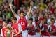LONDON, UNITED KINGDOM: Arsenal's Martin Keown with his sons Niall (L) and Callum (2ndL) raises his arms as he is being saluted by teammates before kick off in a testimonial football match for himself against England X1 at Highbury in north London, 17