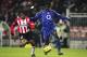 EINDHOVEN, NETHERLANDS - NOVEMBER 24: Kolo Toure of Arsenal holds off Jefferson Farfan of PSV Eindhoven during the UEFA Champions League Group E match between PSV Eindhoven and Arsenal at the Phillips Stadium on November 24, 2004 in Eindhoven, Netherland