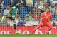 Real Betis' forward from Paraguay Arnaldo Sanabria (L) heads the ball, against Real Madrid's goalkeeper from Costa Rica Keylor Navas, to score a goal during the Spanish league football match Real Madrid CF against Real Betis at the Santiago Bernabeu stad