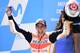 Repsol Honda Team's Spanish rider Marc Marquez celebrates on the podium winning the MOTO GP race of the Moto Grand Prix of Aragon at the Motorland circuit in Alcaniz on September 24, 2017. / AFP PHOTO / JOSE JORDAN (Photo credit should read JOSE JO