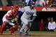 ANAHEIM, CA - MAY 18: Carl Crawford #3 of the Los Angeles Dodgers runs to first base as Carlos Perez #58 of the Los Angeles Angels of Anaheim stands during a baseball game between the Los Angeles Angels of Anaheim and the Los Angeles Dodgers at Angel Sta