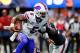 ATLANTA, GA - OCTOBER 01: Tyrod Taylor #5 of the Buffalo Bills slips away from Grady Jarrett #97 of the Atlanta Falcons and Takkarist McKinley #98 during the second half at Mercedes-Benz Stadium on October 1, 2017 in Atlanta, Georgia. (Photo by Kevin C.