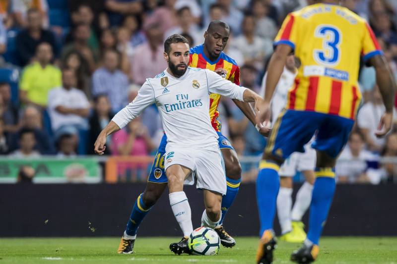 MADRID, SPAIN - AUGUST 27: Daniel Carvajal Ramos (l) of Real Madrid competes for the ball with Geoffrey Kondogbia of Valencia CF during their La Liga 2017-18 match between Real Madrid and Valencia CF at the Estadio Santiago Bernabeu on 27 August 2017 in M