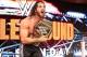 Seth Rollins clutches the WWE Championship.
